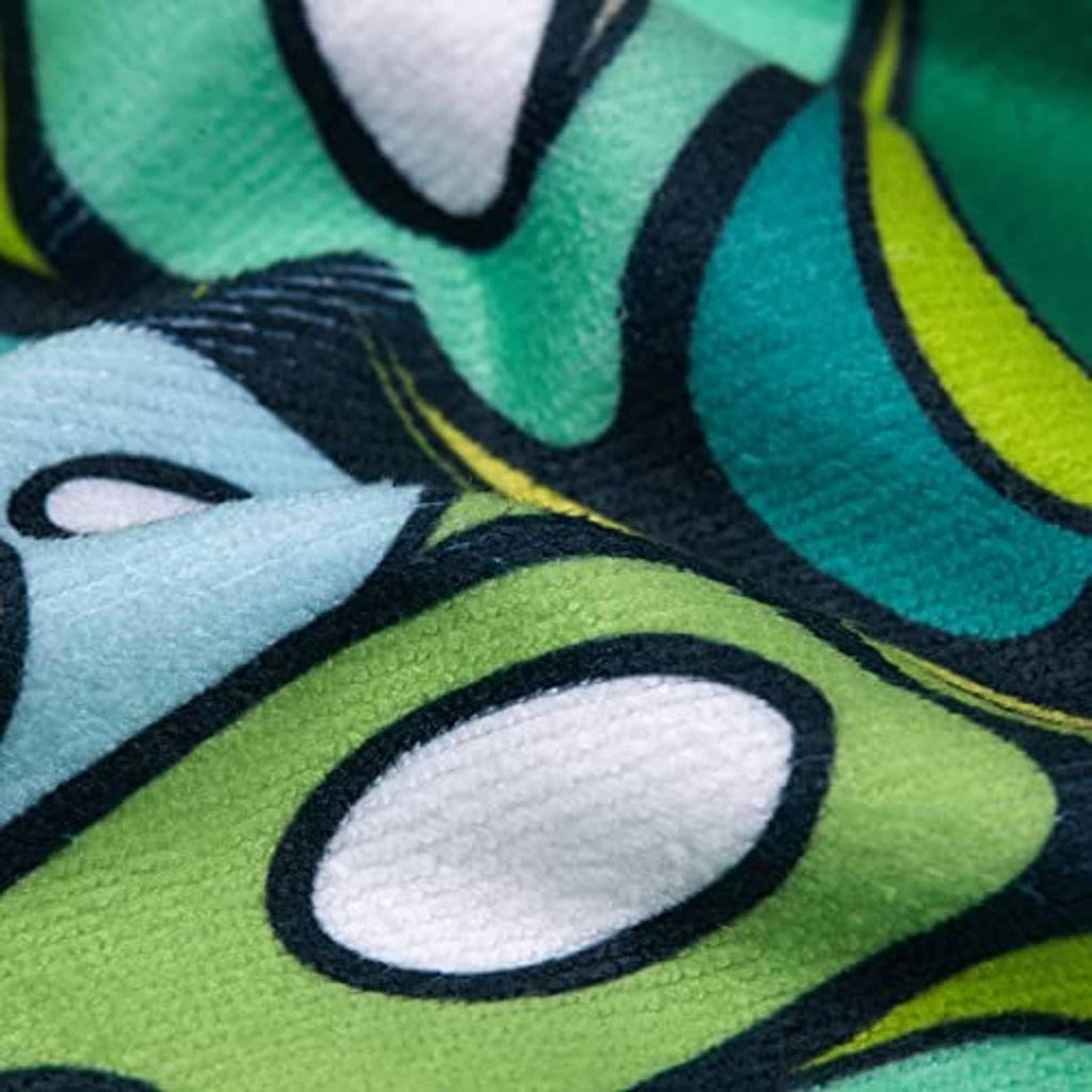 Golf cart seat cover fabric close-up: multicolor tropical pattern on printed textile