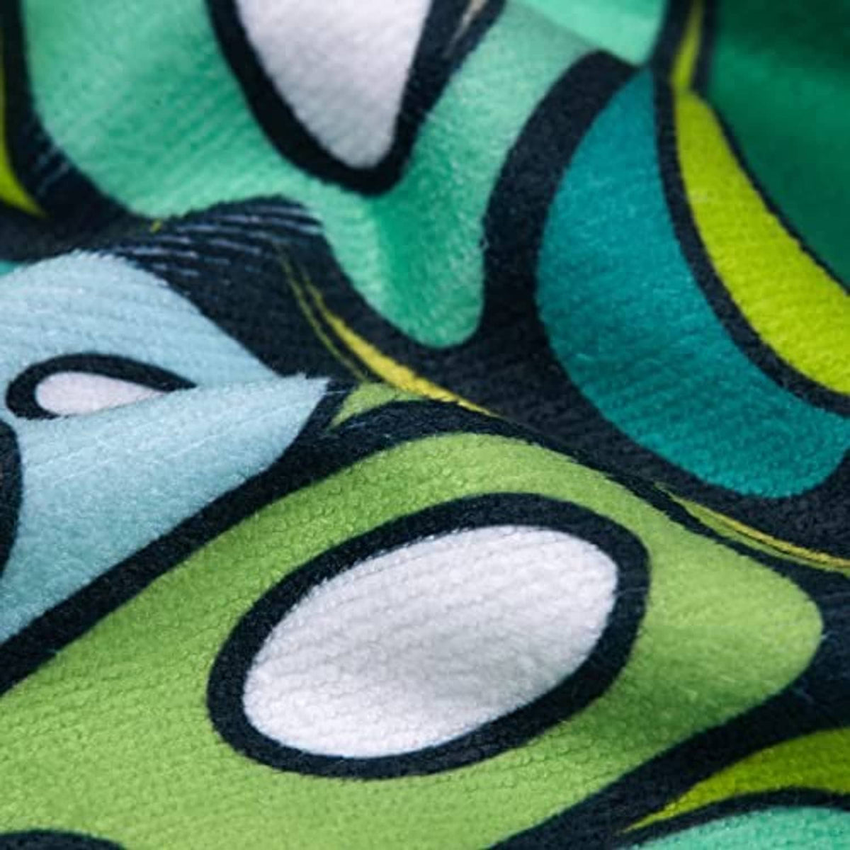 Golf cart seat cover fabric close-up: multicolor tropical pattern on printed textile