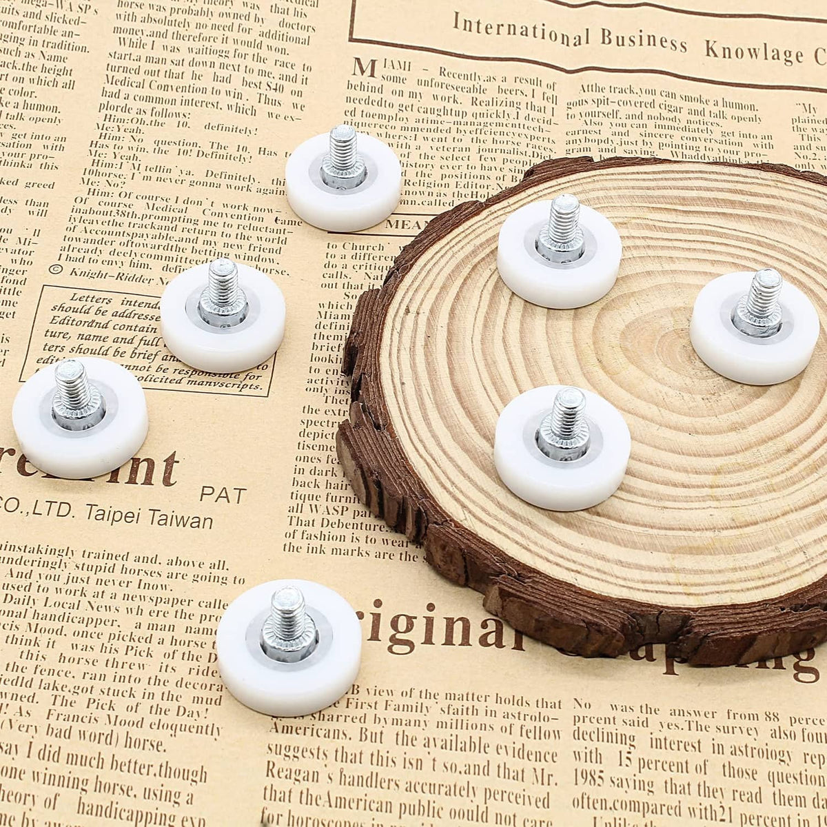 White drawer slide roller wheels with metal screws on cut wood base