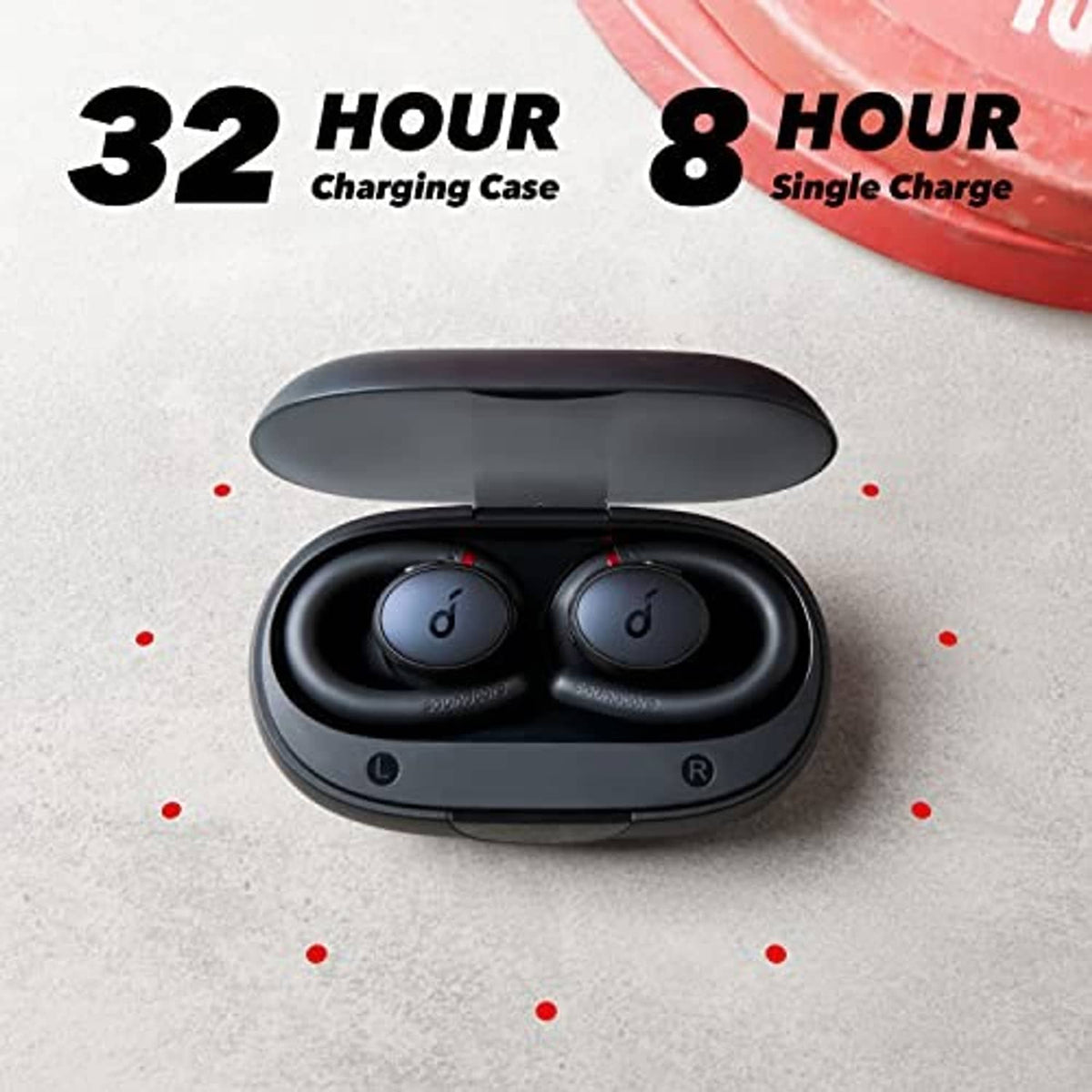 Black true wireless earbuds seated in open charging case, charging contacts visible.