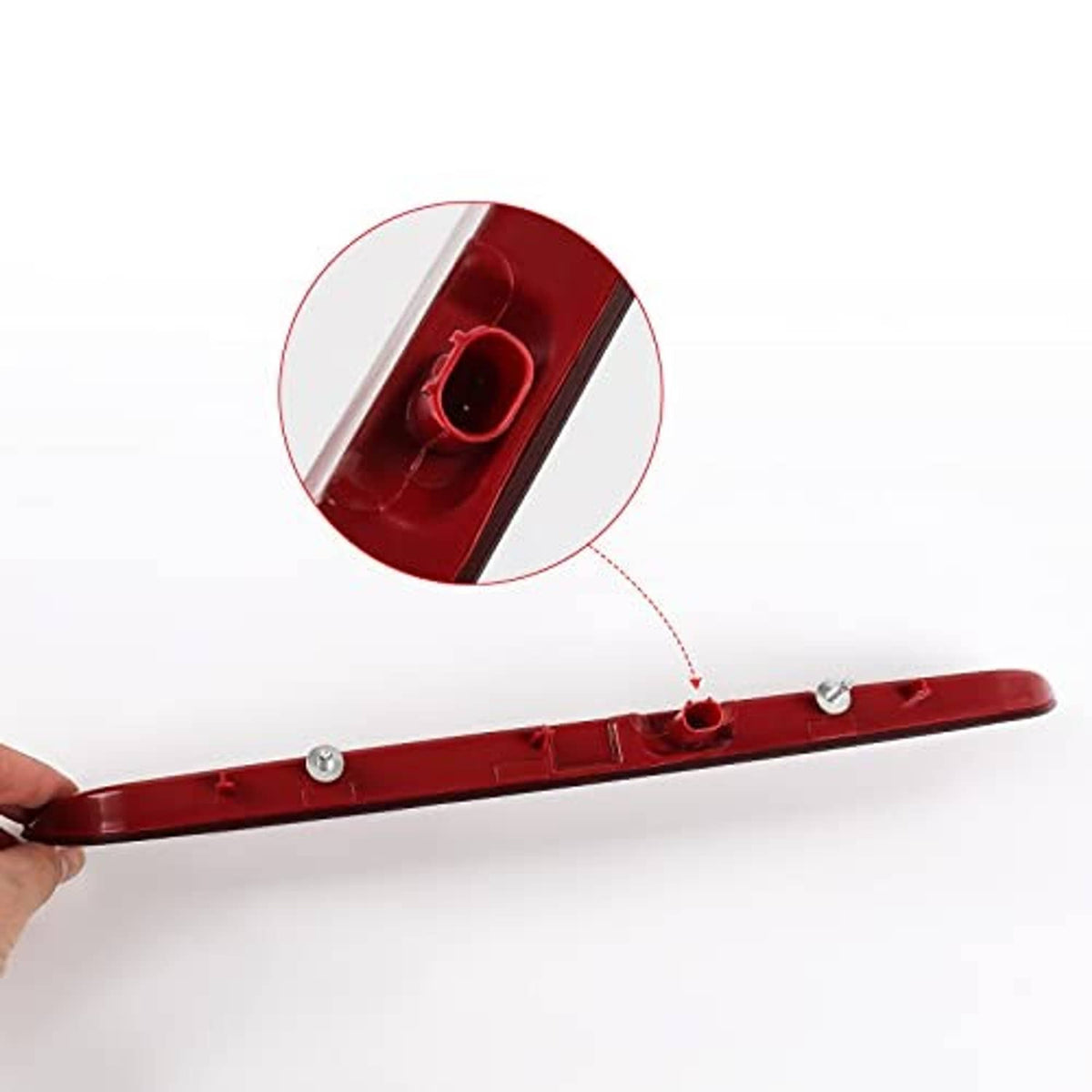 Red third brake light bar held by hand, with wiring and mounting studs visible