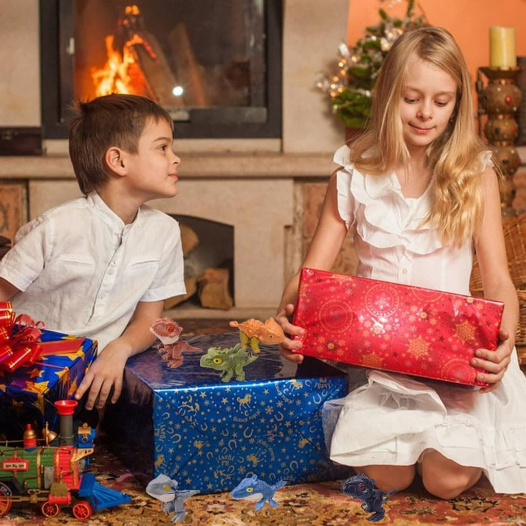 Kids holding a gift with biting finger dinosaur toy figures on the table