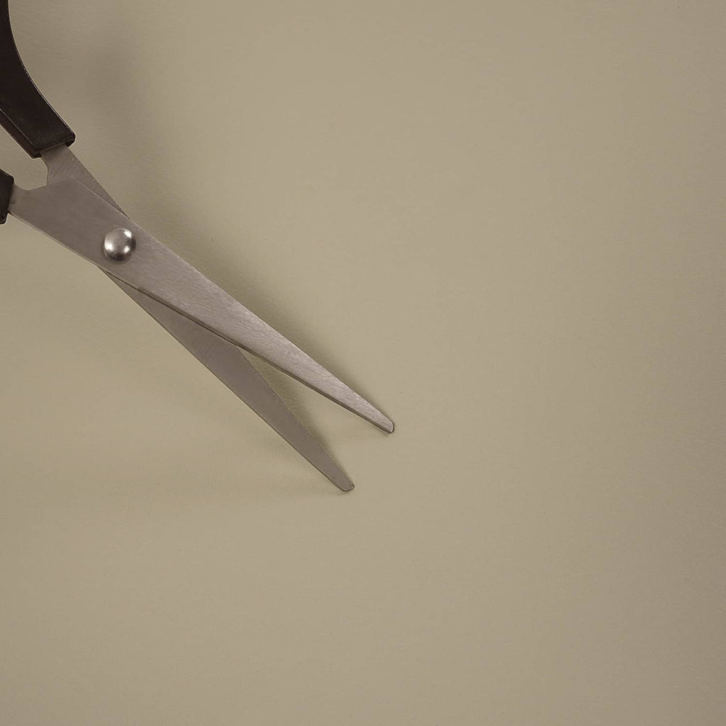 Beige cushion surface with metal snap-ring pliers near the edge