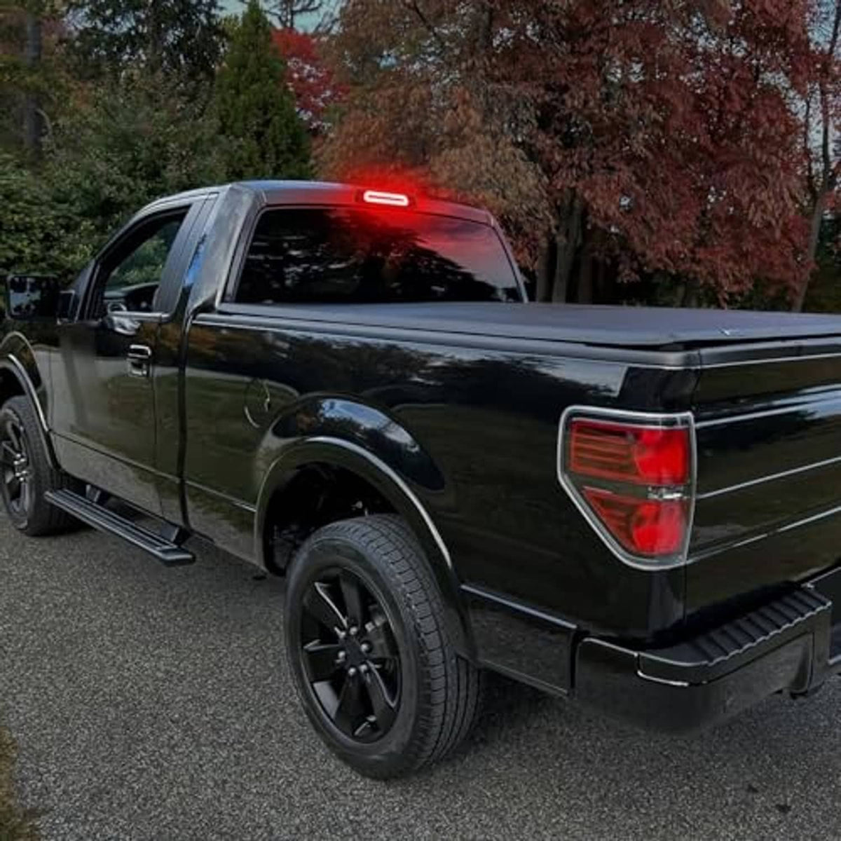 LED third brake light on dark pickup truck showing red glowing LED strip