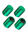 Set of 4 green metal tire valve stem caps with black plastic liner inserts