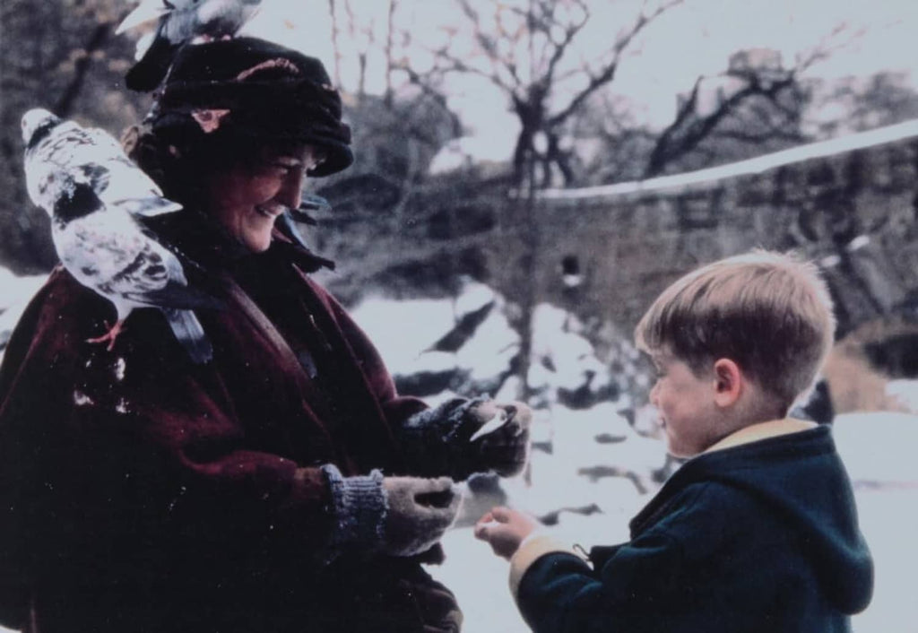 Printed photo insert showing people outdoors, one person holding a gift