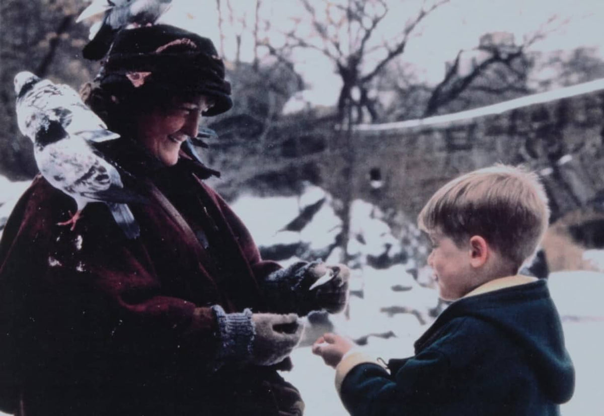 Printed photo insert showing people outdoors, one person holding a gift