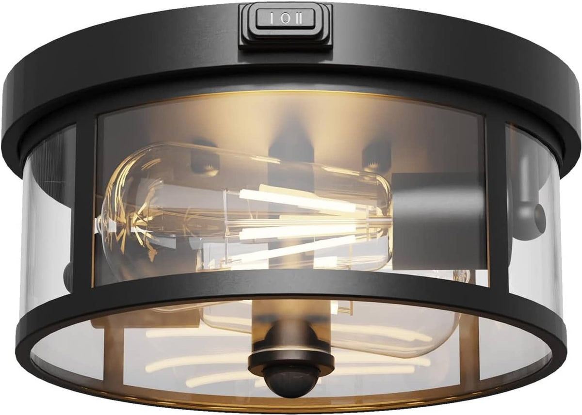 Black outdoor ceiling light fixture with motion sensor panel and clear glass shade