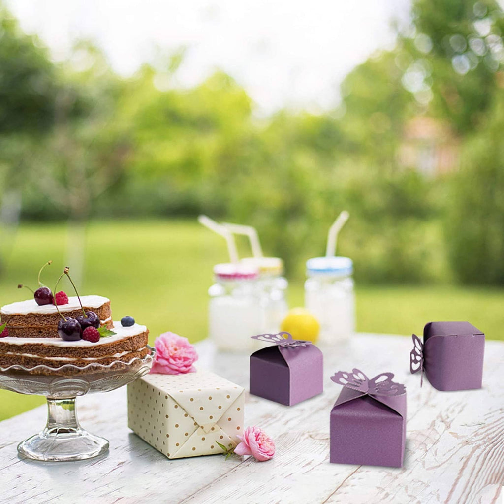 Purple butterfly favor boxes on display, small cube boxes with butterfly cutout lids