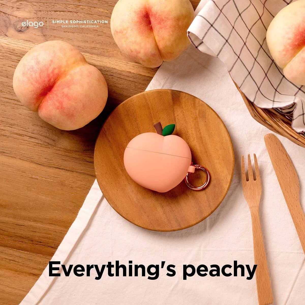 Peach silicone charging case cover with green leaf and rose-gold keyring