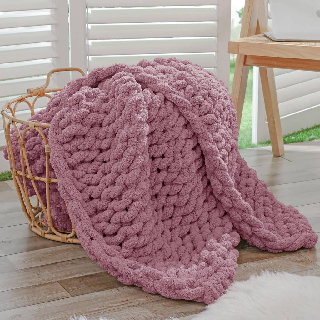 Chunky knit throw blanket, burnt rose, thick looped texture, draped with soft fold