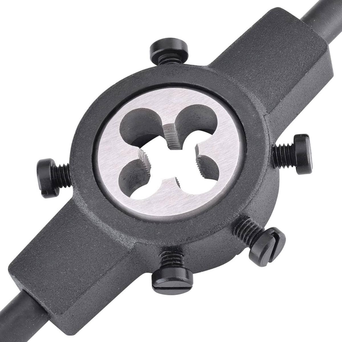 Threading die mounted on a dark holder, circular silver die with four cutting openings