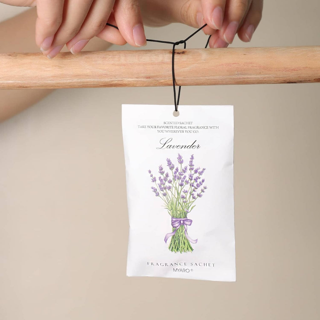 Lavender fragrance sachet held by a black string, white bag with lavender bouquet art