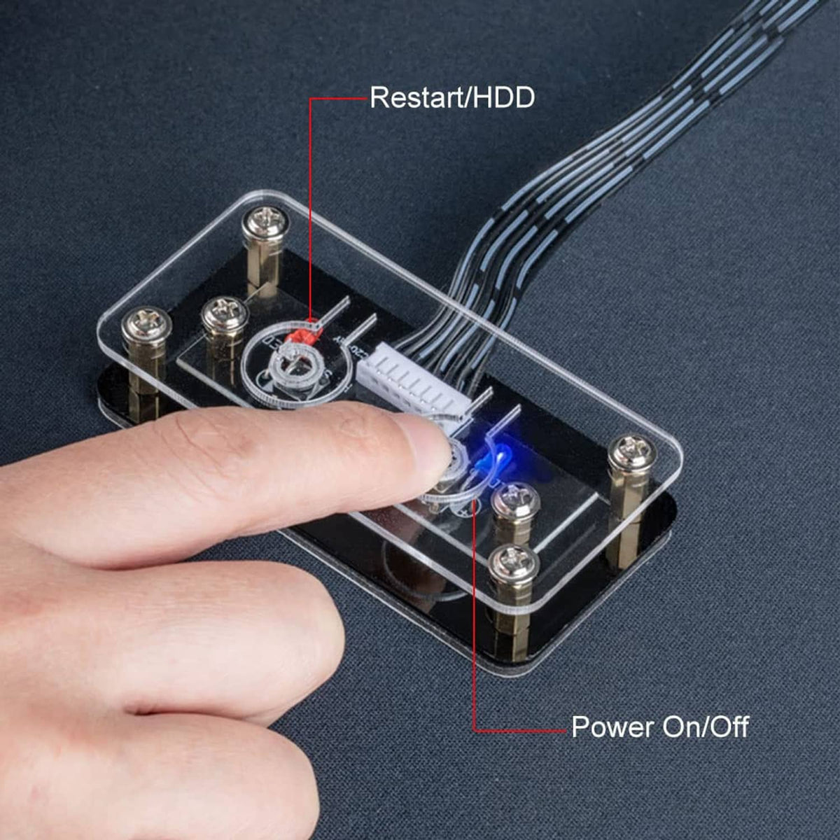 Desktop front panel power on/off switch with LED buttons and connector pins, close-up.