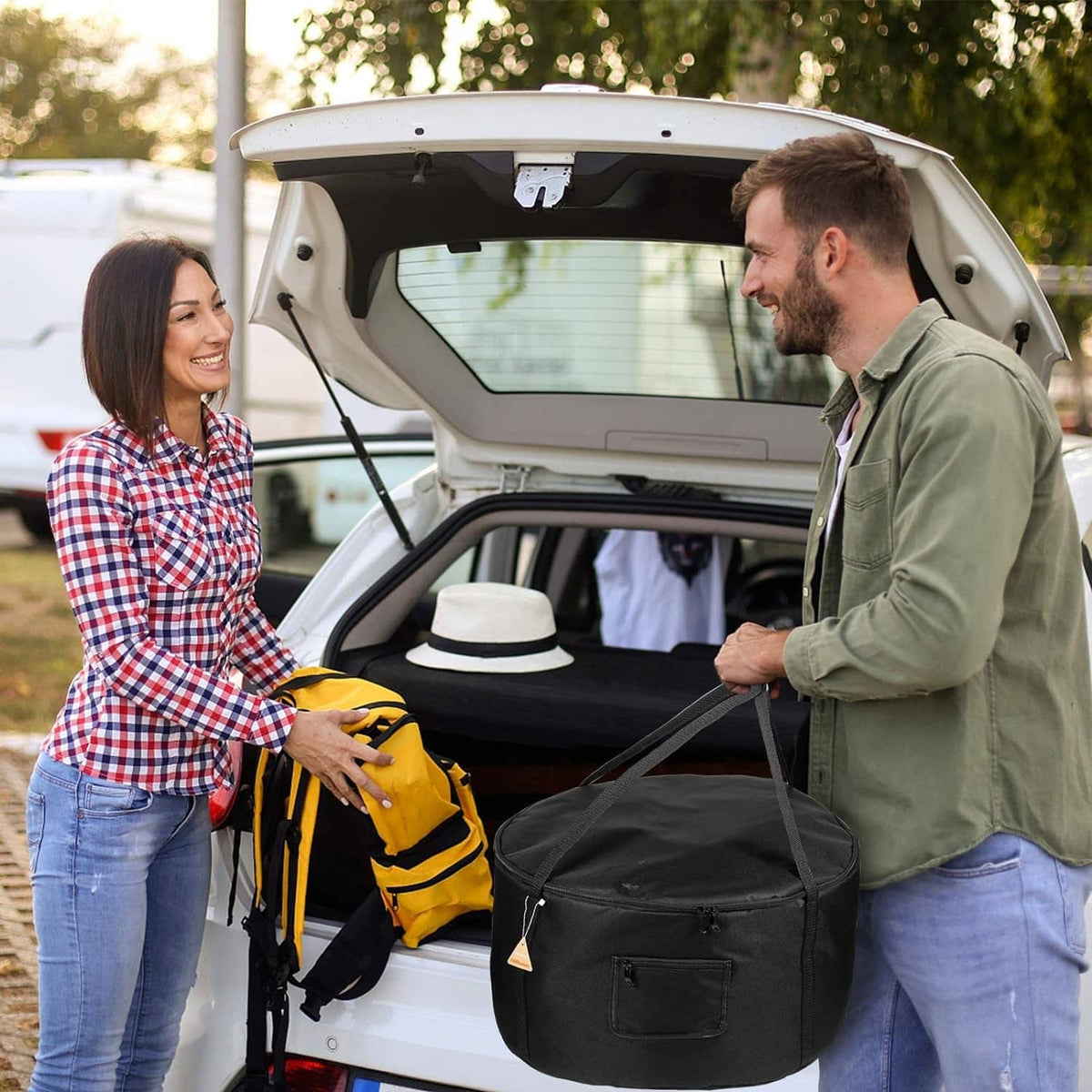 Black portable firebowl carrying bag opened in trunk with side zipper compartment