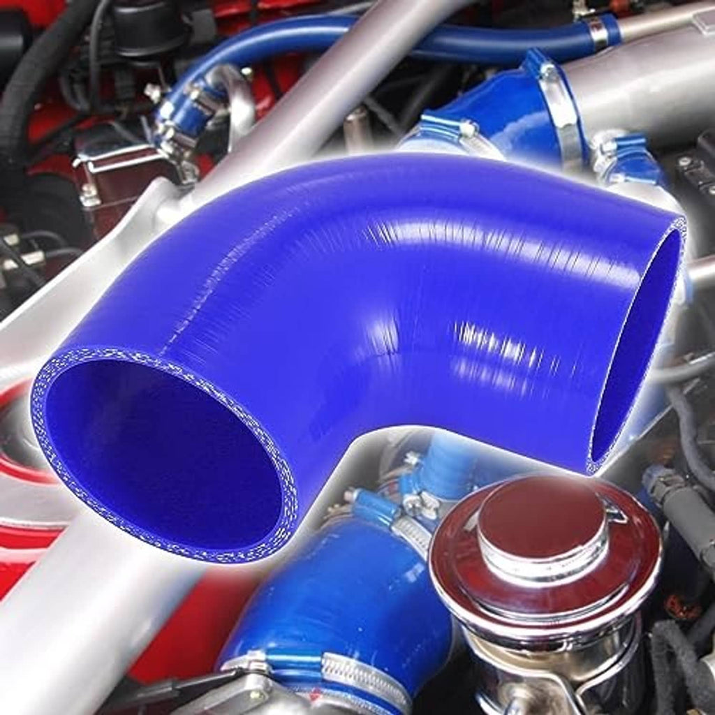 Blue 90-degree silicone hose elbow reducer installed in an engine bay, curved shape.