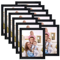 Stack of black 8x10 photo frames showing multiple fronts