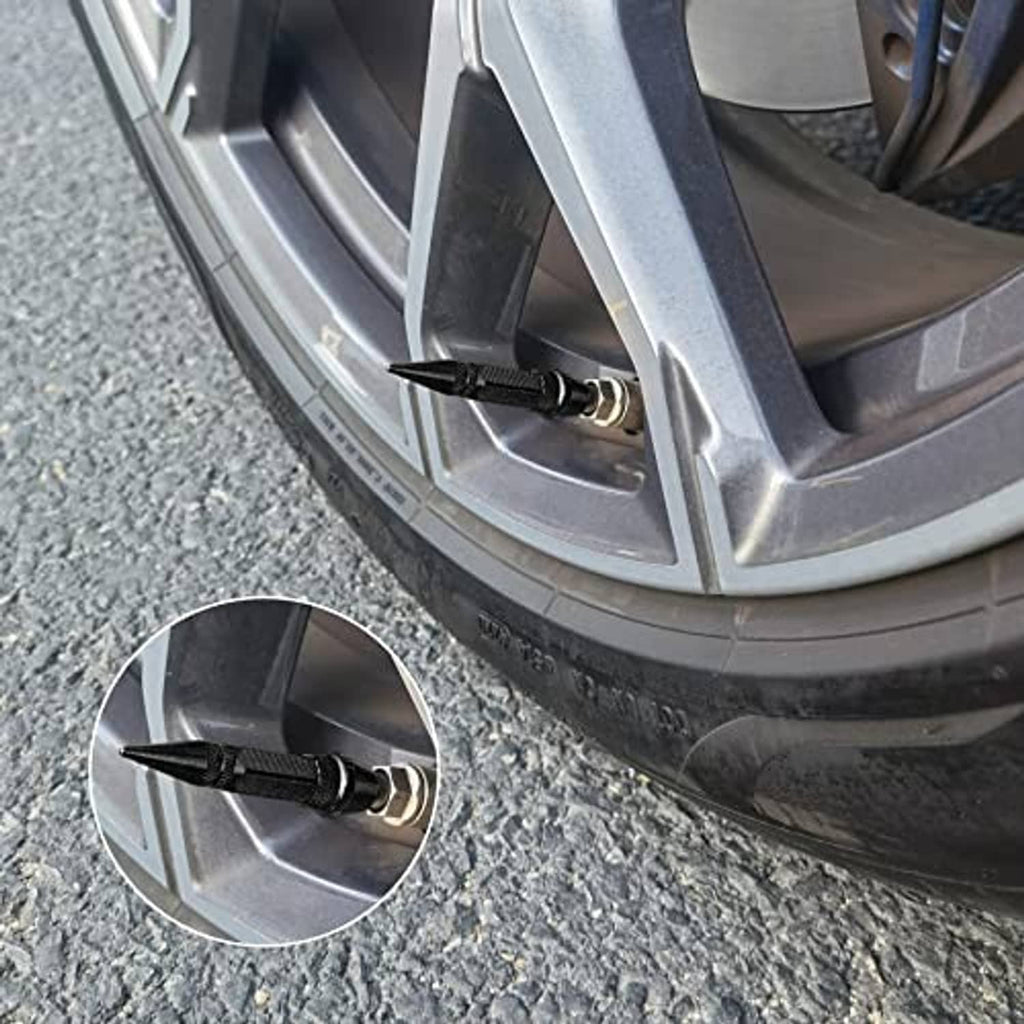 Close-up of a black spiked valve cap on a wheel valve stem for dust protection