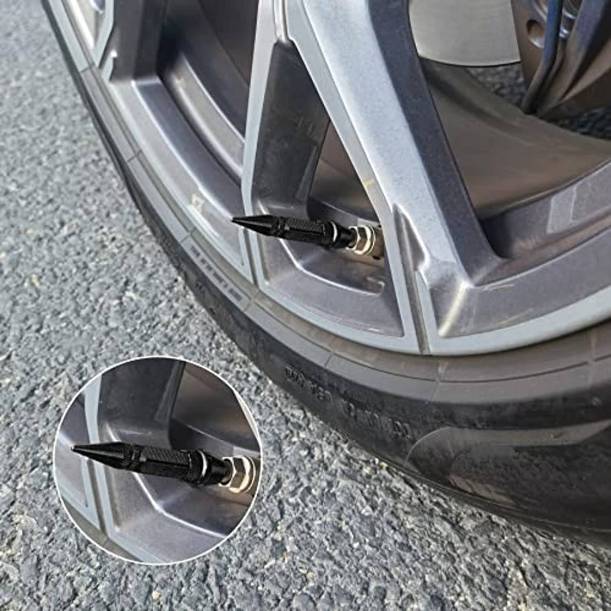Close-up of a black spiked valve cap on a wheel valve stem for dust protection