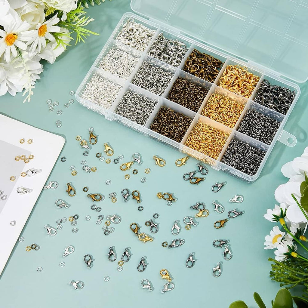 Tray of mixed-color lobster claw clasps and open jump rings with scattered pieces