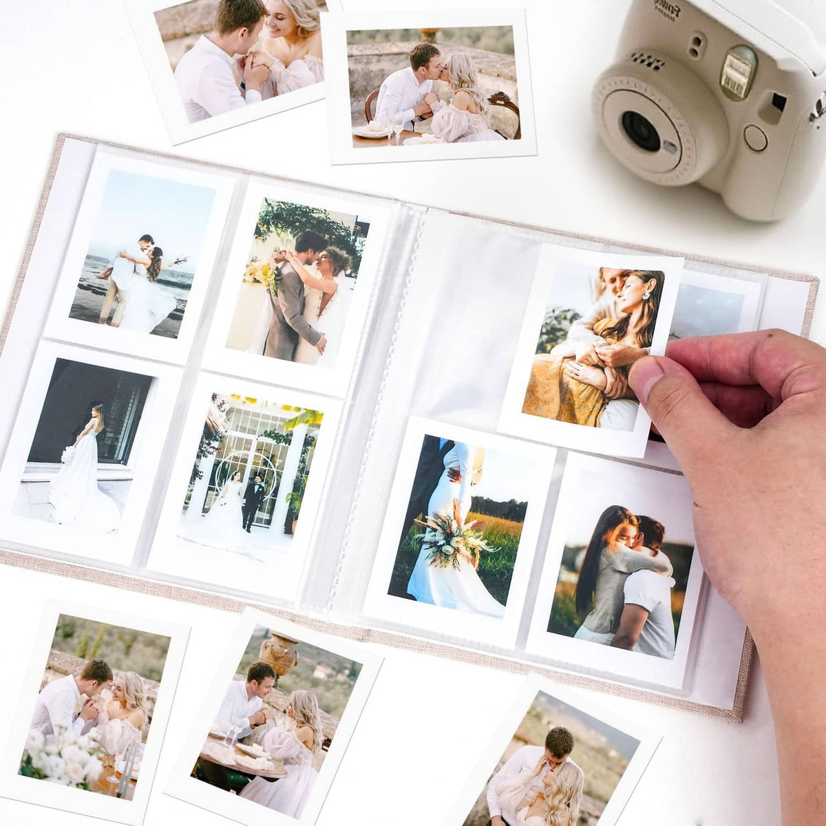 Beige Polaroid photo album book open with 2x3 photos in clear pockets