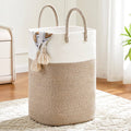 Two-tone woven cotton rope laundry hamper with curved handles and tassel front detail.