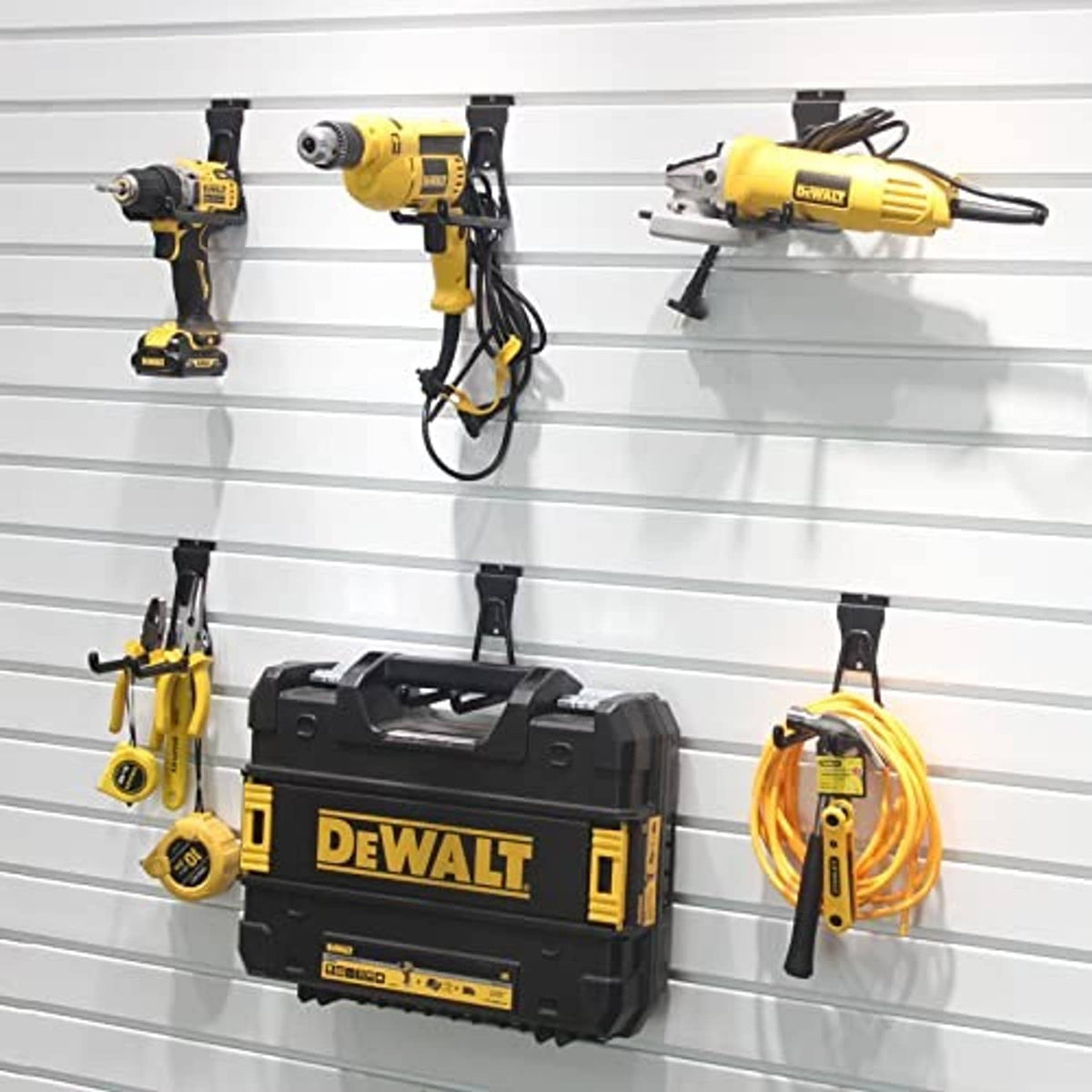 Black slatwall U hooks mounted on slatwall, with curved arms for hanging items