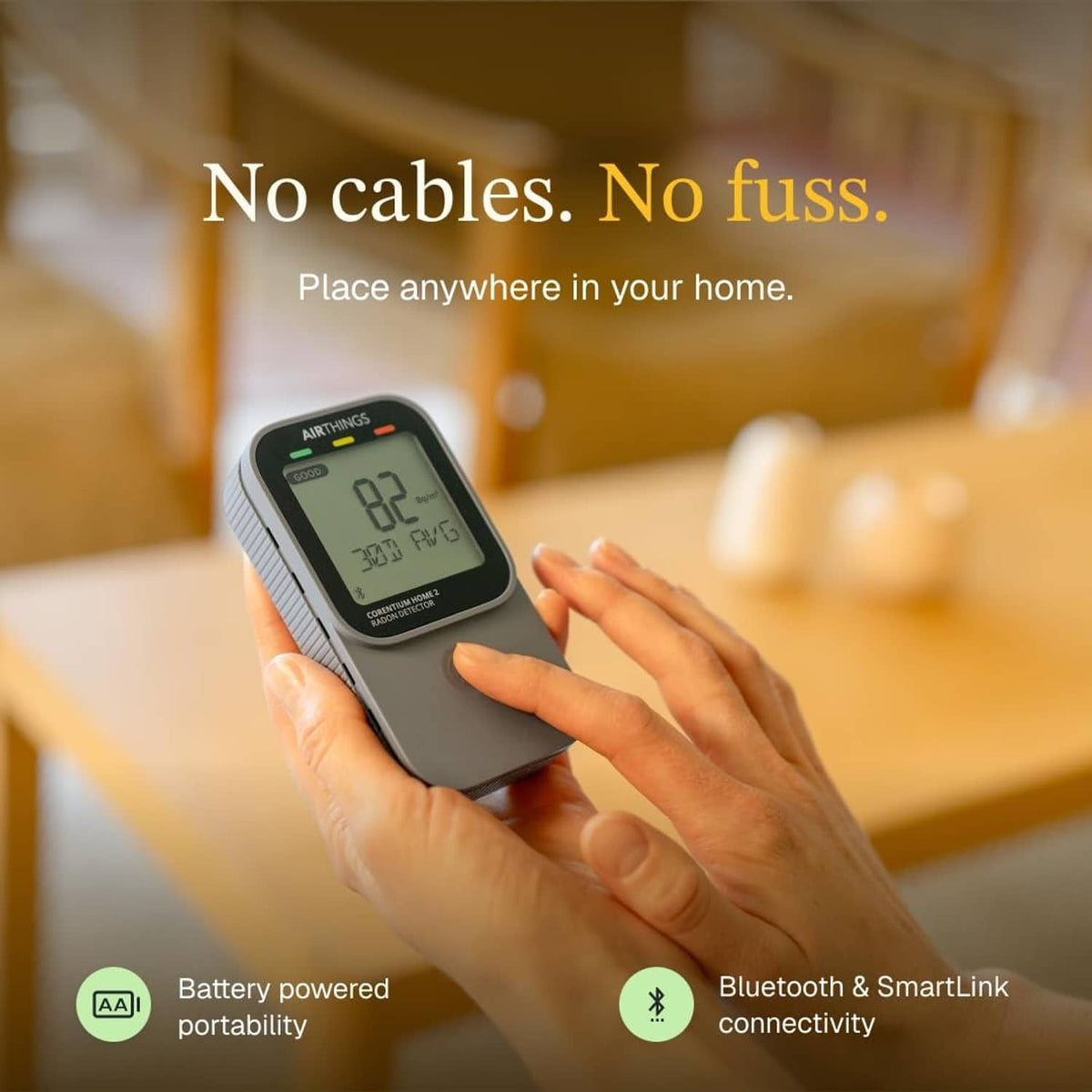 Hand holding black digital radon detector with LCD showing a radon reading