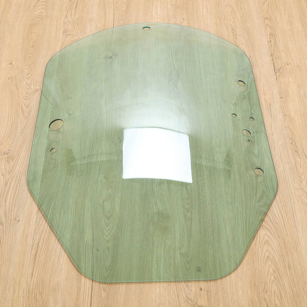 Green cab door glass panel with mounting holes and reflective center area.