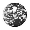Spare tire cover with skull and hand motif, black-and-white round design