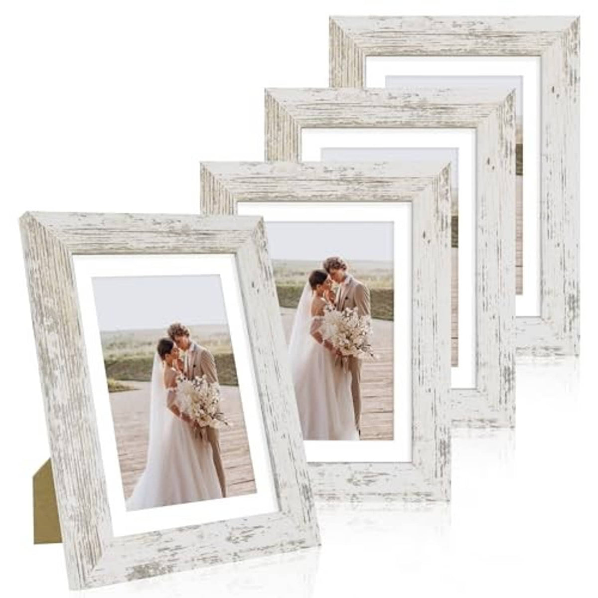 Set of four distressed white 5x7 frames standing with wedding portrait photos
