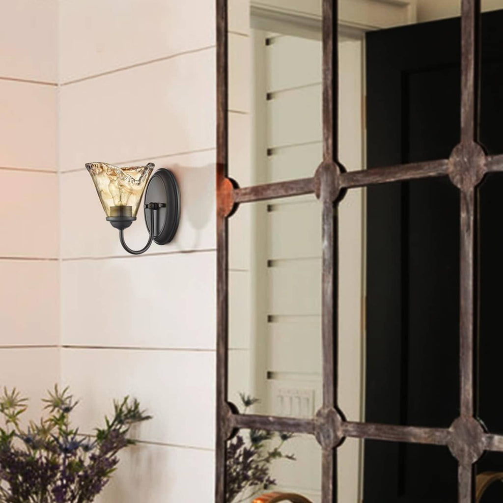Vintage wall sconce with amber art glass shade on exterior-style wall panel