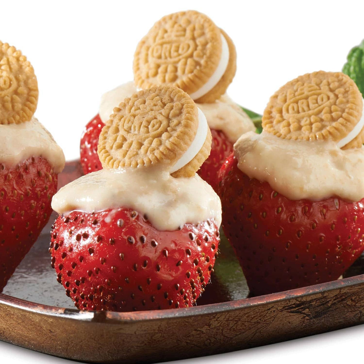 Cream-topped strawberry halves with Oreo minis cookie pieces