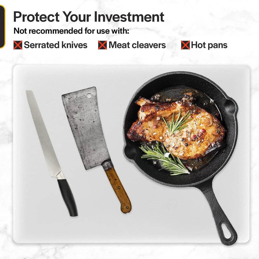 White plastic cutting board with chef knife and meat pan, ready for prep