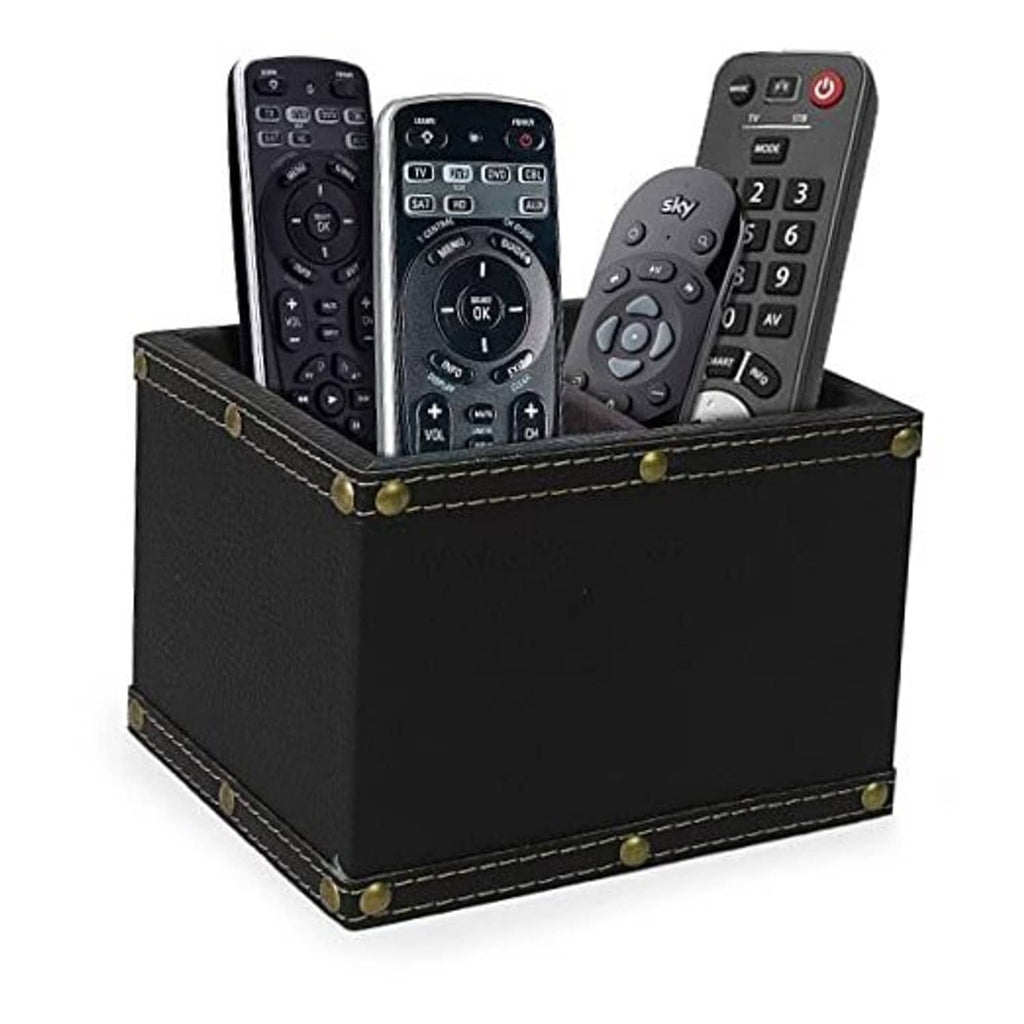 Black leather remote holder with stitched seams and brass studs, holding three remotes