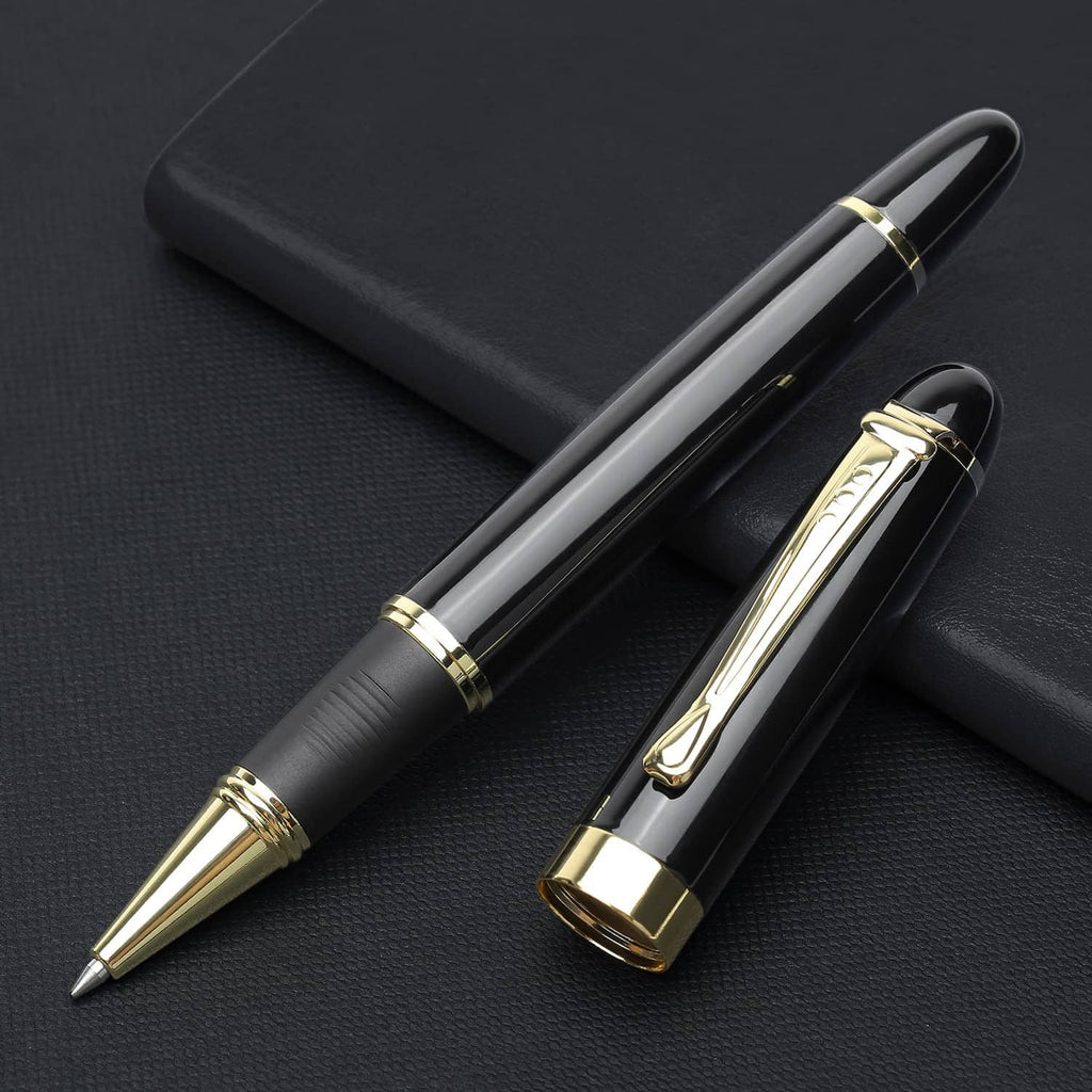 Black luxury ballpoint pen with gold cap and clip, lying on a case