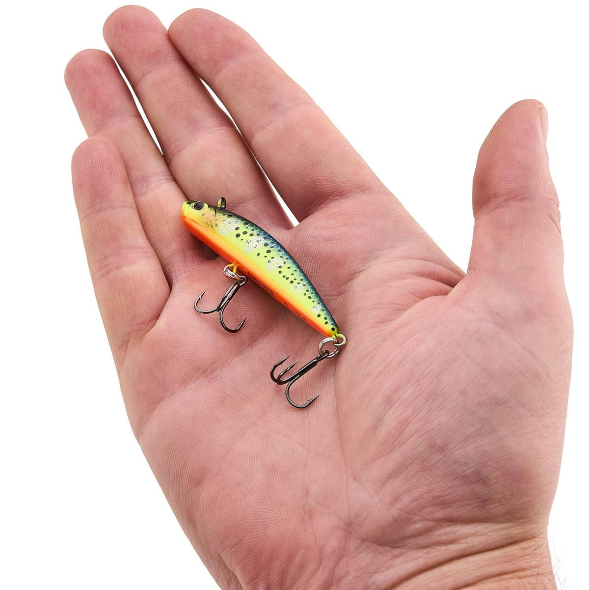 Berkley Finisher fishing lure in hand, green-yellow spotted body with two treble hooks