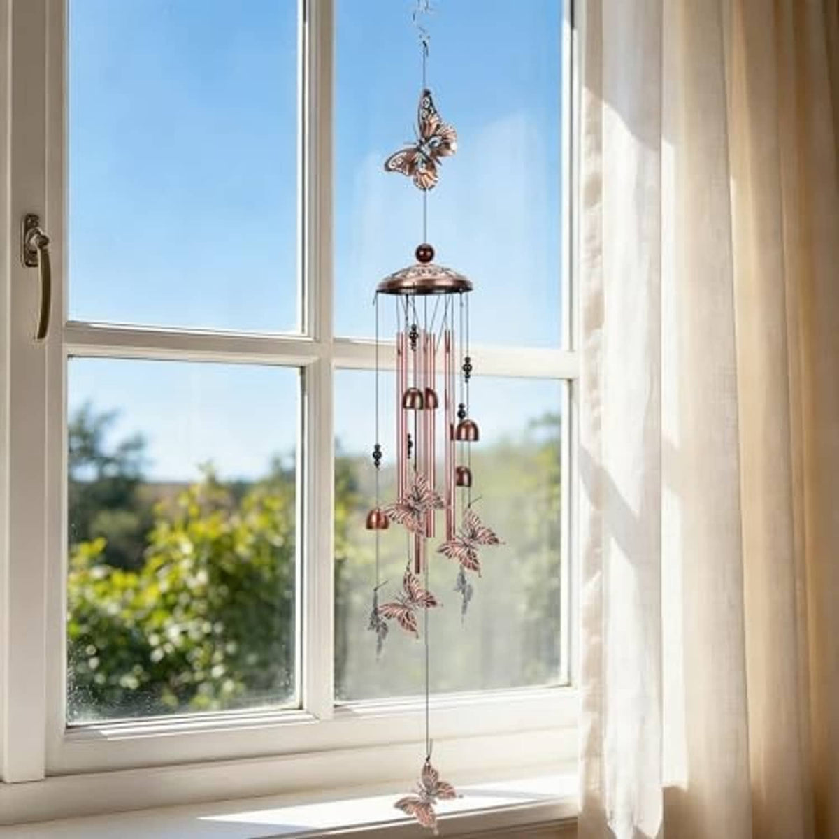 Copper-tone butterfly wind chime with round top and multiple dangling metal tube chimes