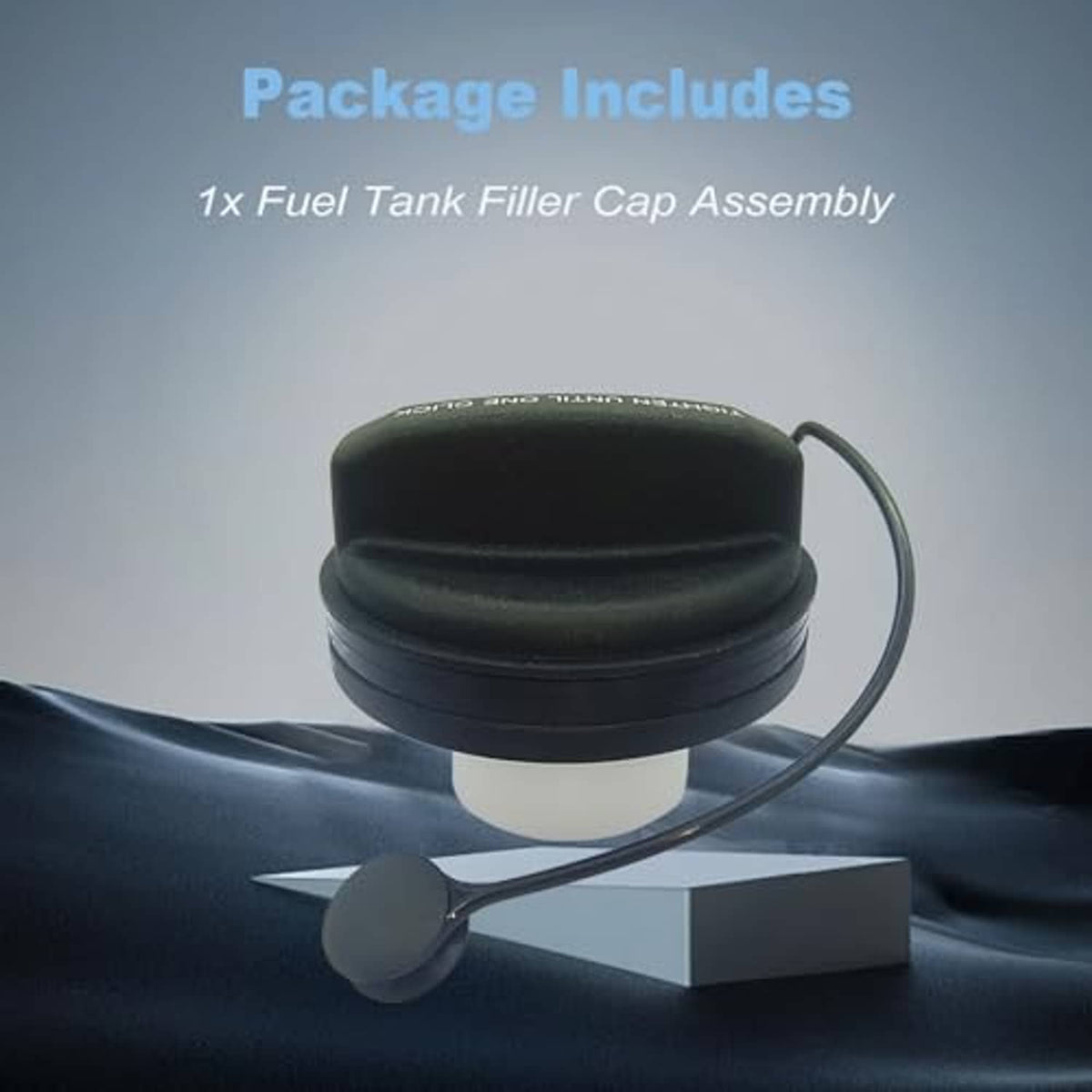 Black fuel tank filler cap with tether cord and white seal, on display base