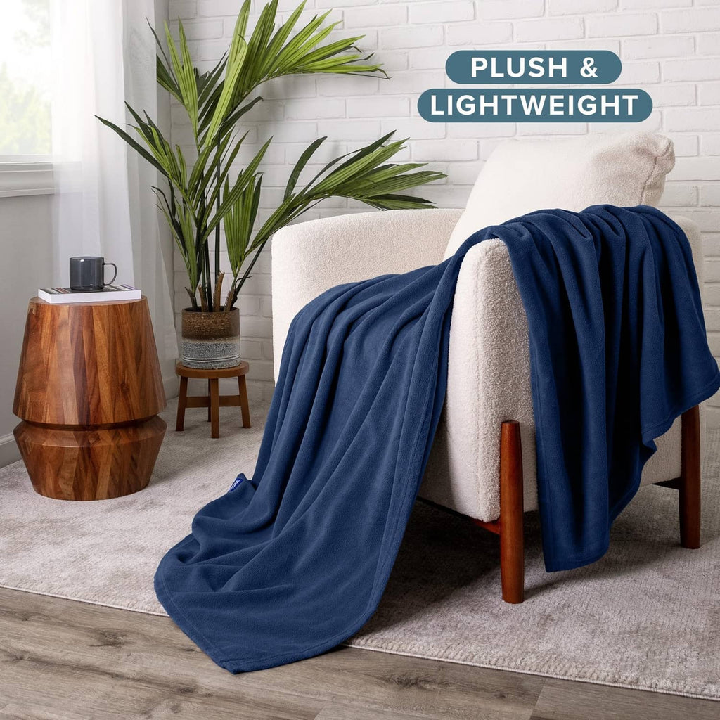 Dark blue blanket draped over an armchair, plush and lightweight look