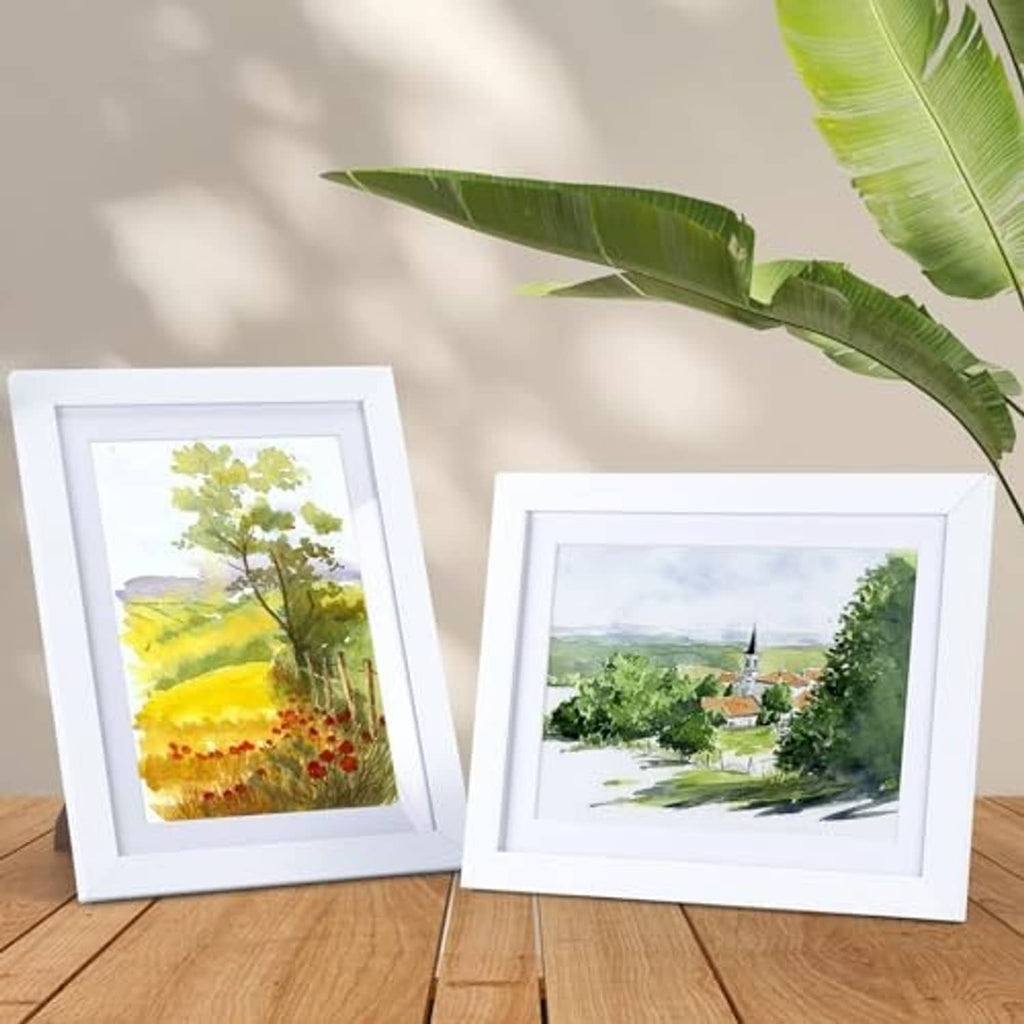 Two white picture frames with white borders, each displaying artwork print