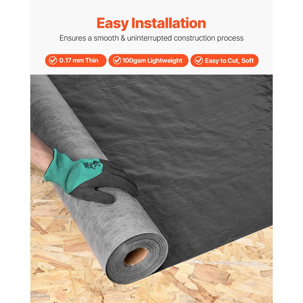 Black house wrap roll being unrolled on wooden deck with protective glove