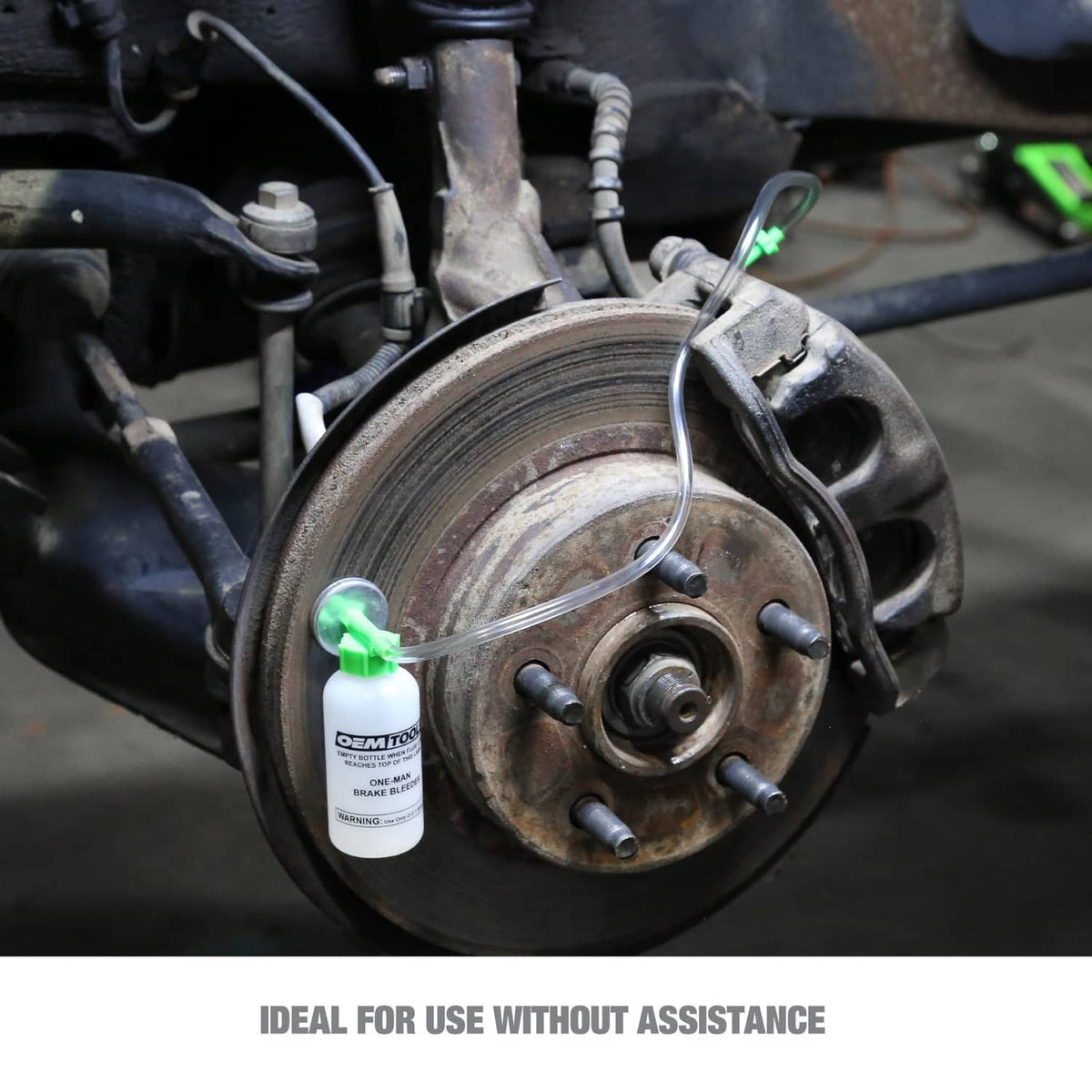 Brake bleeder bottle positioned on a vehicle wheel hub during service