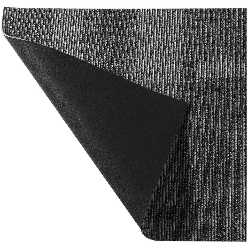 Gray carpet tile corner showing attached padding backing and ribbed texture