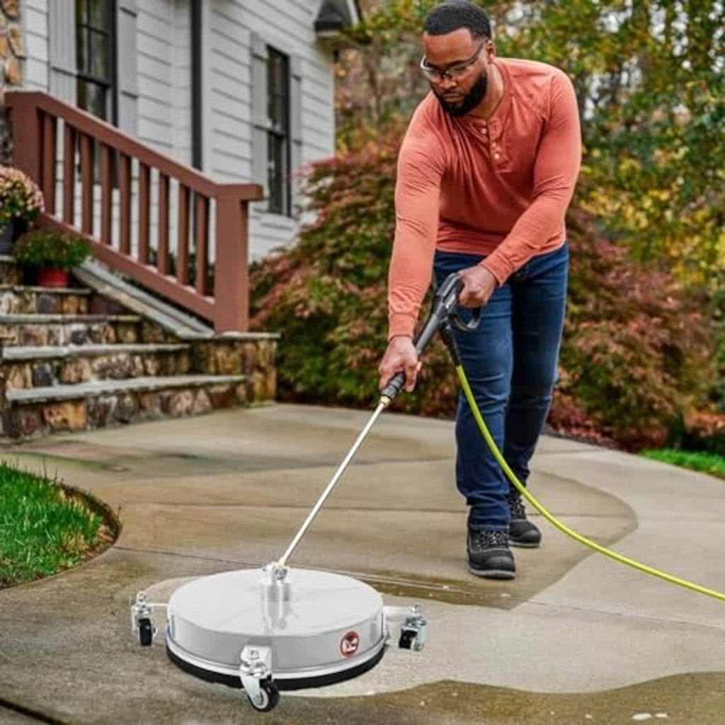 Stainless steel surface cleaner with caster wheels on a driveway