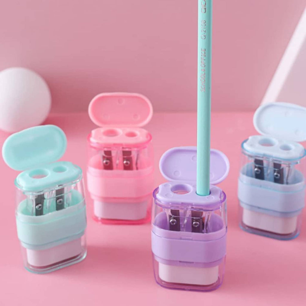 Assorted pastel manual pencil sharpeners with open lids and double-hole blade openings