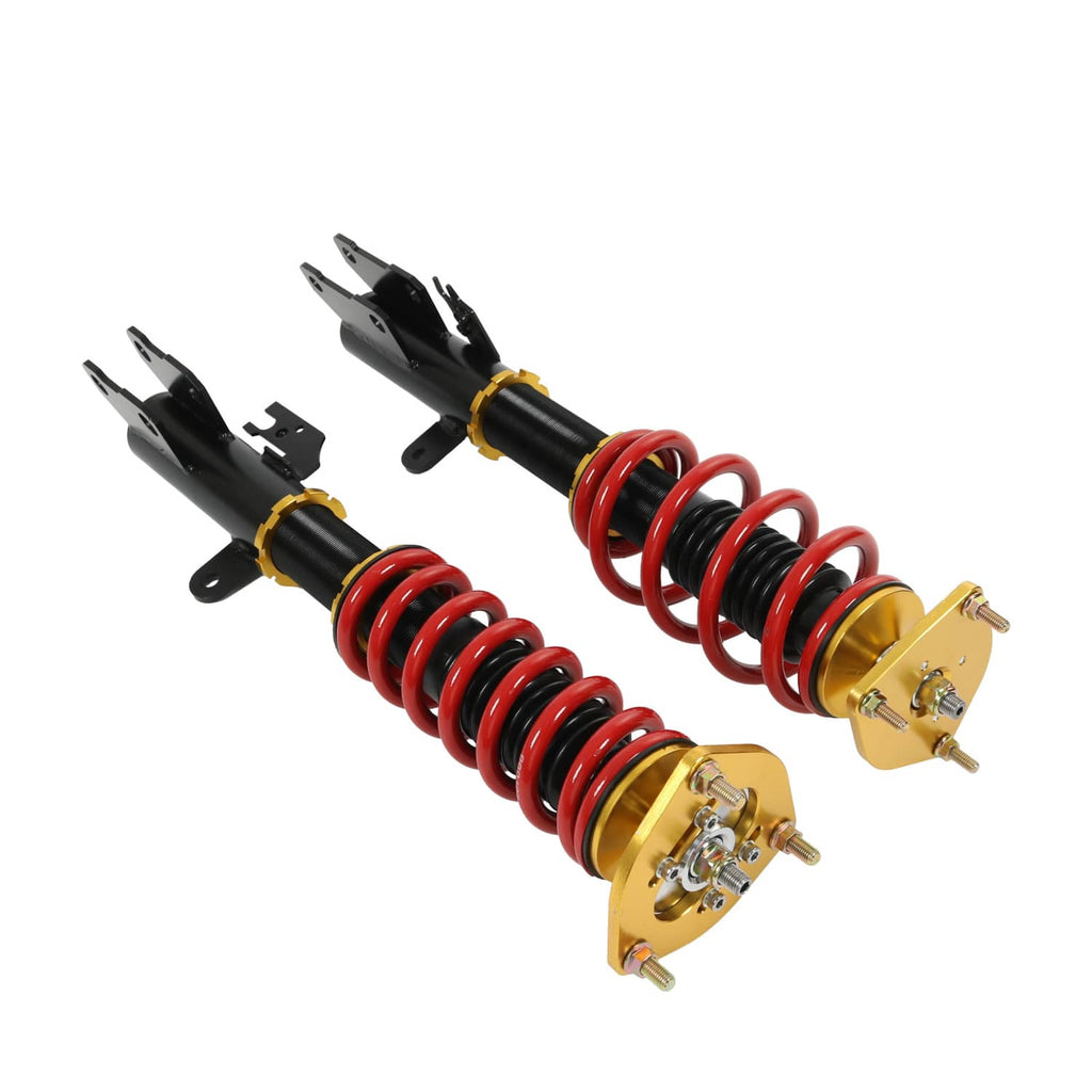 Two coilover suspension struts with red coil springs, black shocks, gold top plates