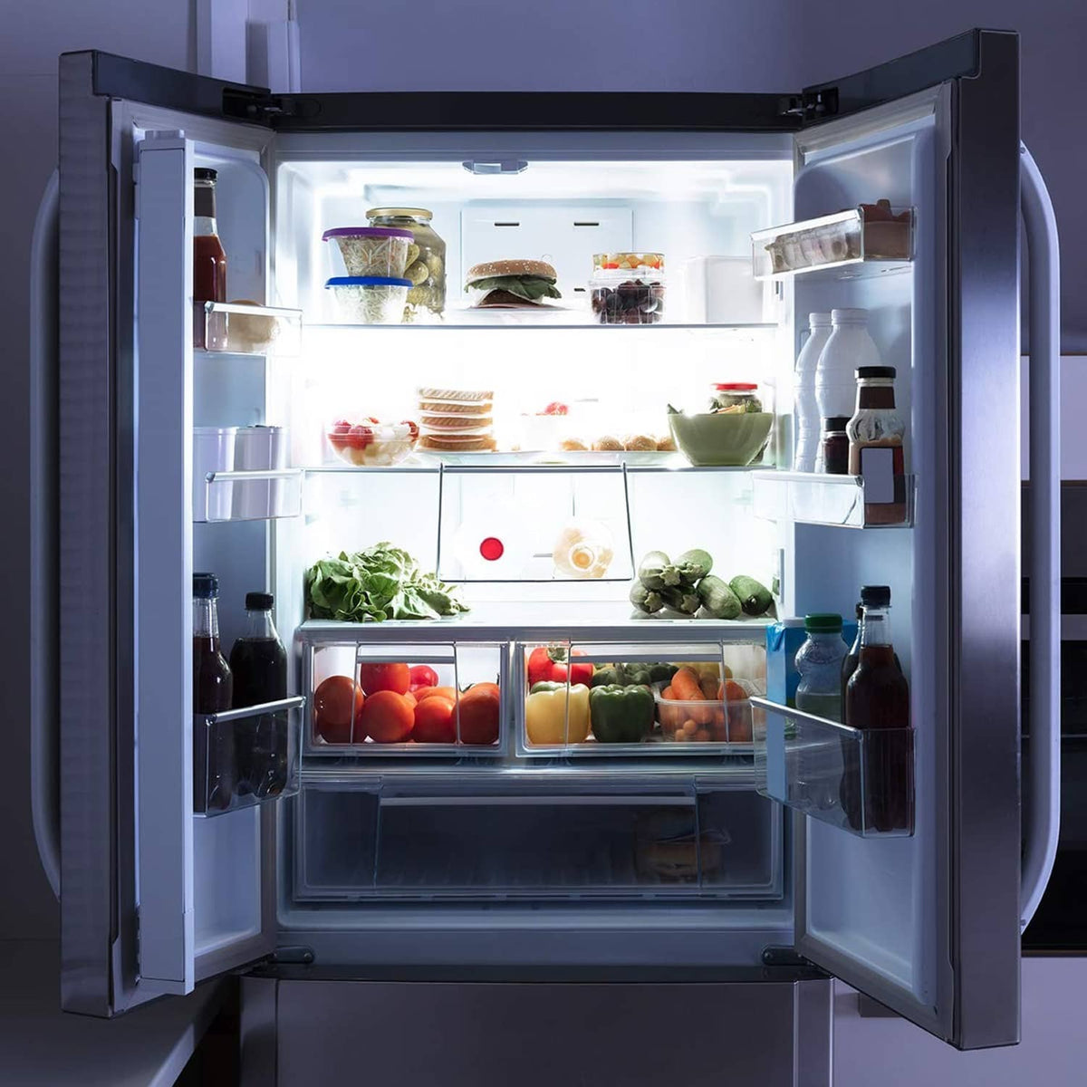 Open refrigerator with bright interior illumination from LED light bulbs