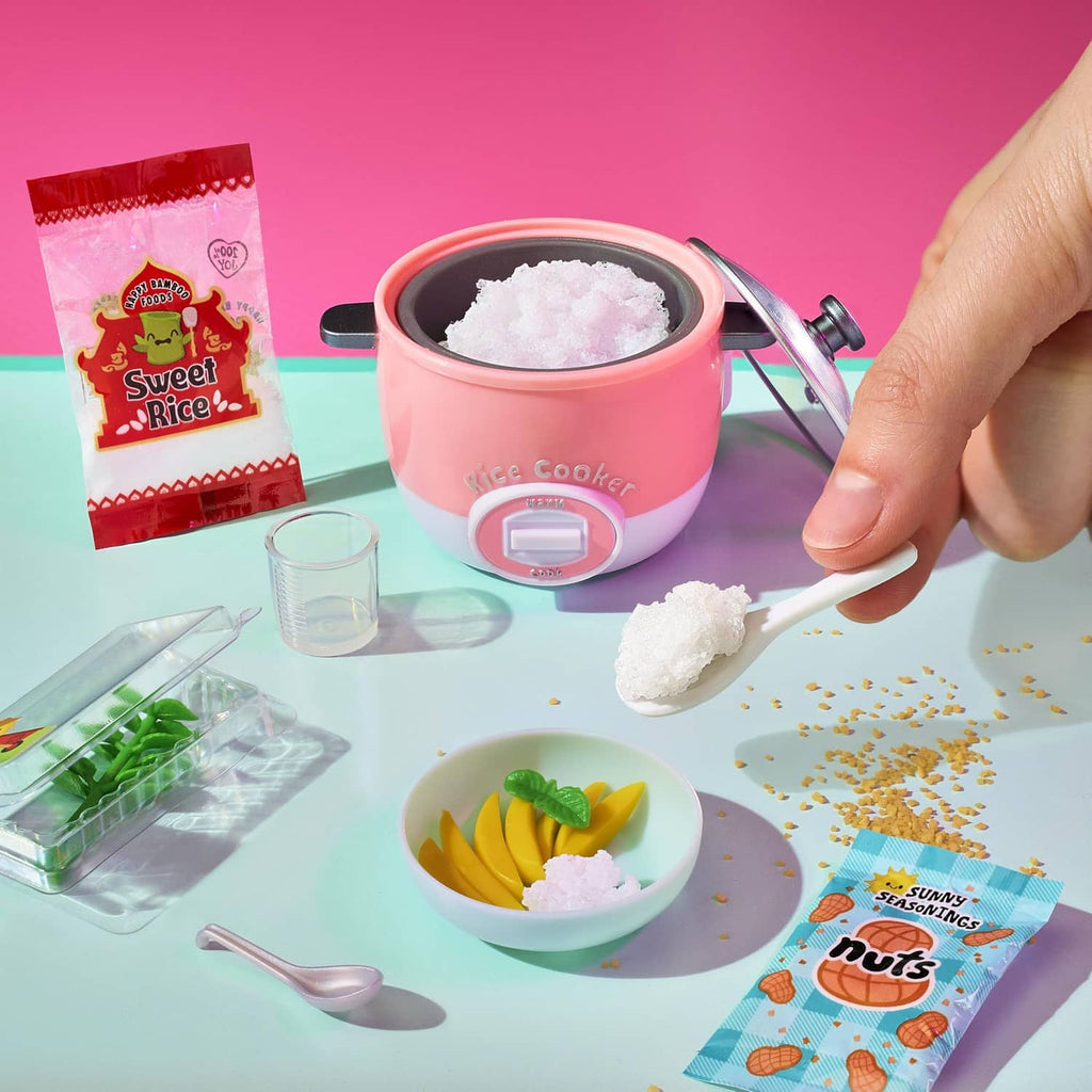 Mini slow-cooker appliance with pink pot, sugar crystals, and recipe mix packet