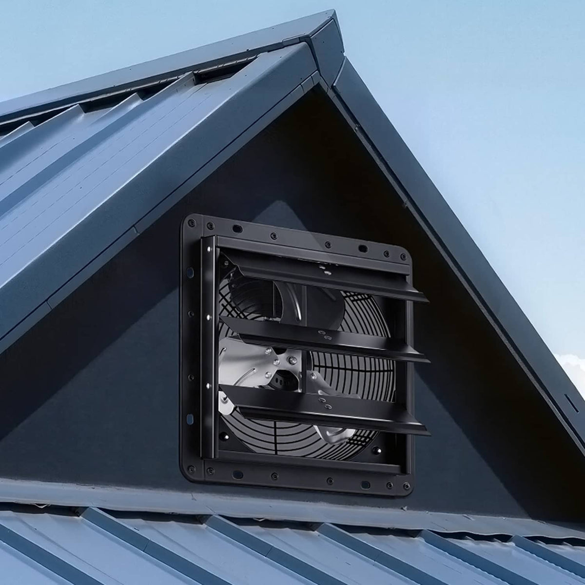 Wall-mounted shutter exhaust fan on exterior siding, black steel frame and louvers.
